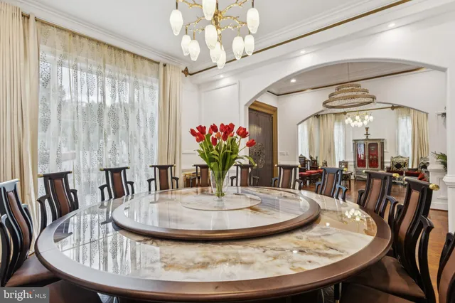 a dining room with furniture entryway and wooden floor