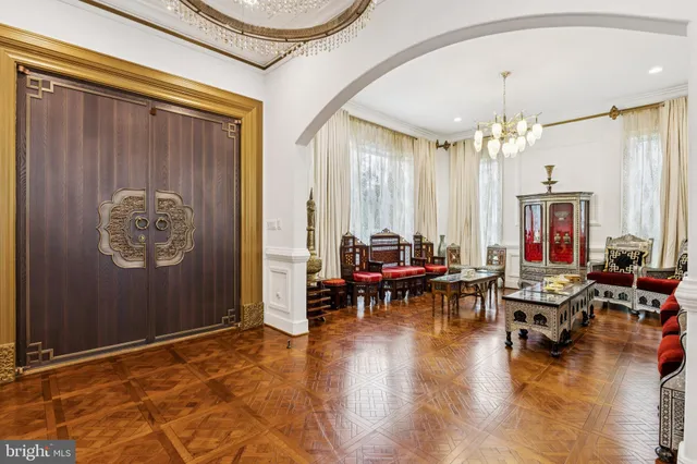 a living room with fireplace furniture and a chandelier
