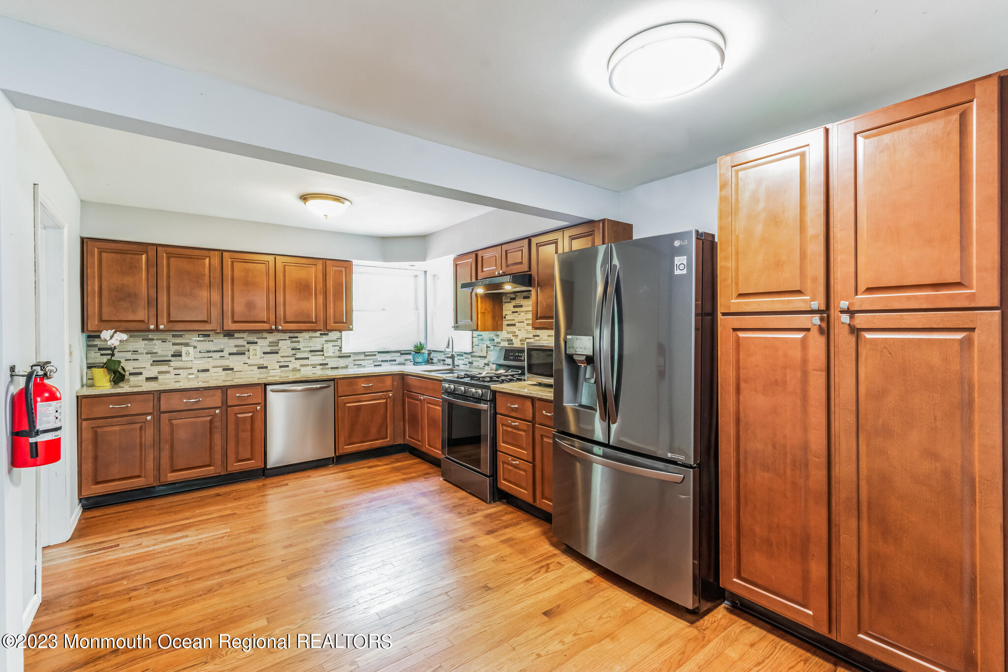 420 Leming Road Jackson, NJ 08527 - Photo 8 of 30 a kitchen with stainless steel appliances granite countertop a refrigerator cabinets and wooden floor