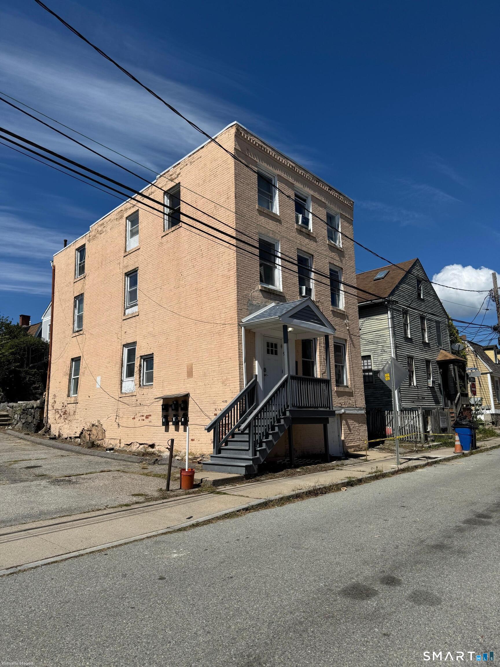97 Green Street, Unit 5 New London, CT 06320 - Photo 1 of 1 a view of a building with car parked