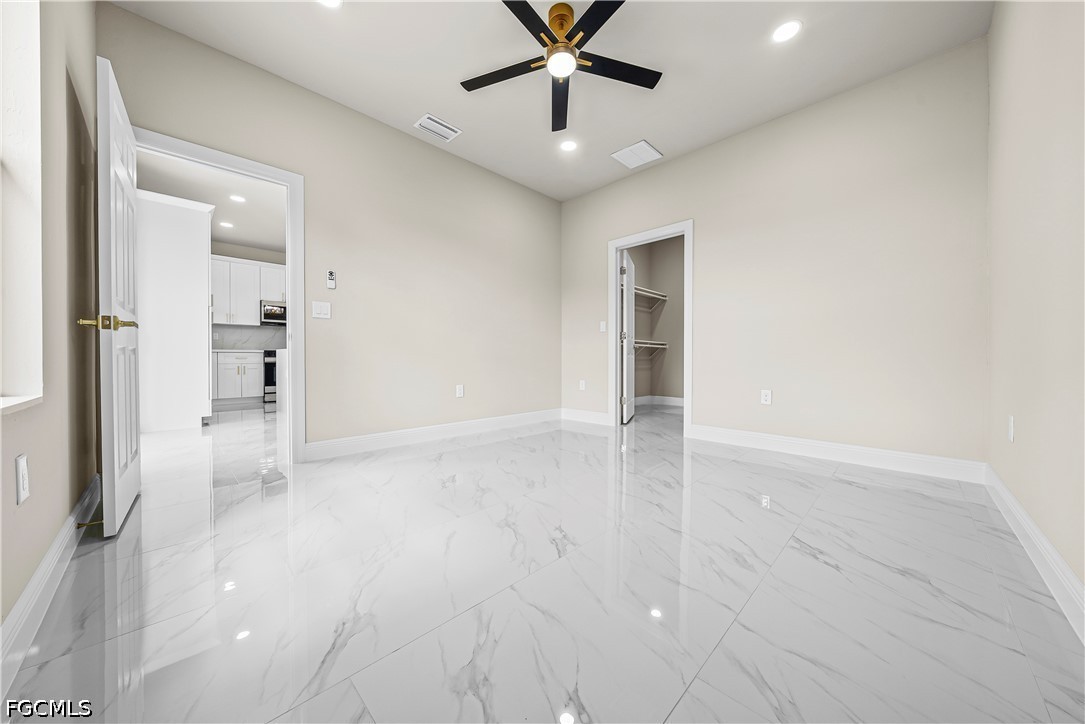 2919 9th Street Southwest Lehigh Acres, FL 33976 - Photo 13 of 29 an empty room with closet and a ceiling fan
