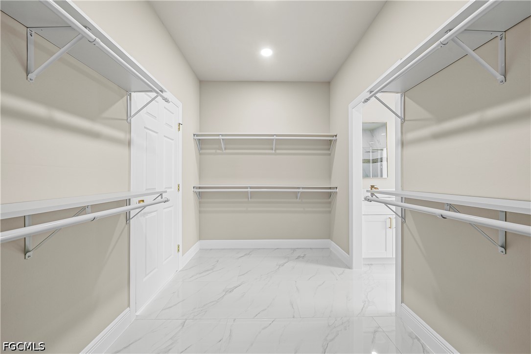 2919 9th Street Southwest Lehigh Acres, FL 33976 - Photo 14 of 29 a view of walk in closet with empty racks