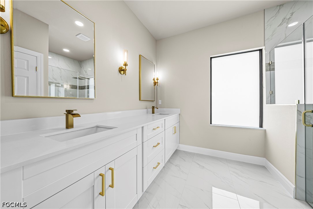 2919 9th Street Southwest Lehigh Acres, FL 33976 - Photo 15 of 29 a bathroom with a sink a vanity and a mirror