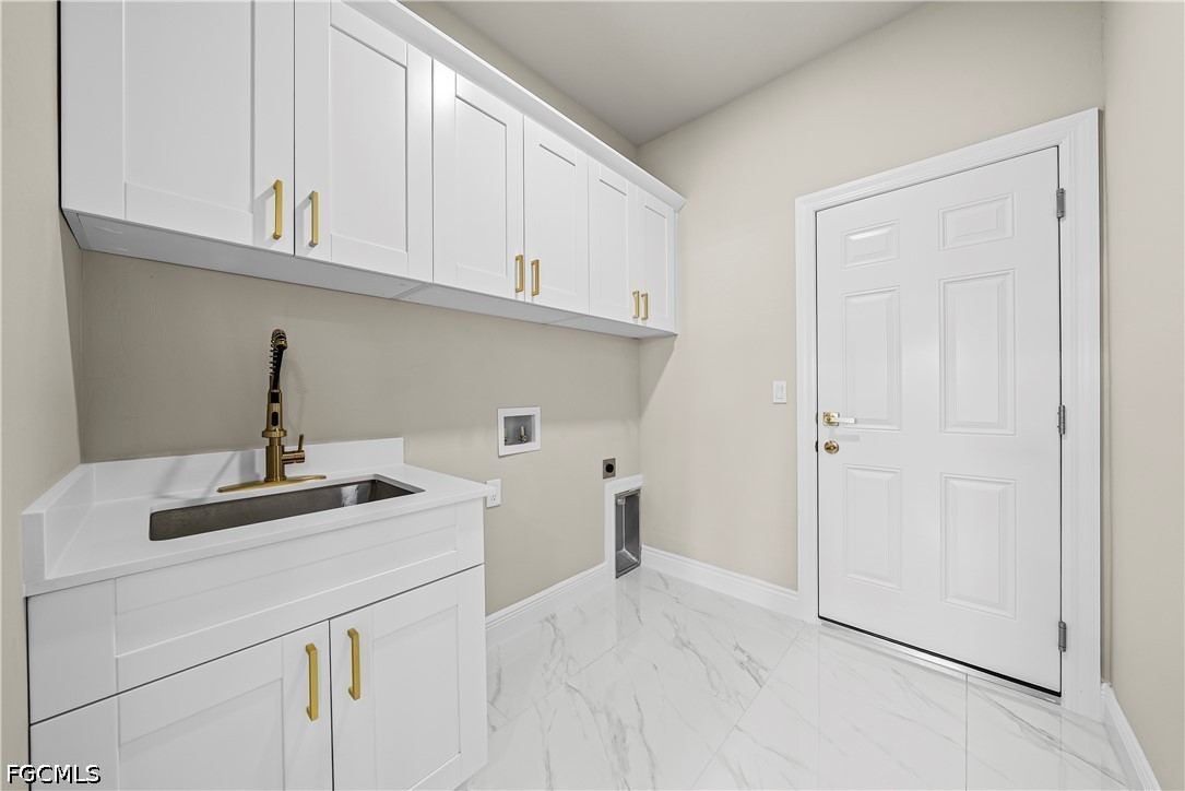 2919 9th Street Southwest Lehigh Acres, FL 33976 - Photo 16 of 29 a kitchen with a sink cabinets and appliances