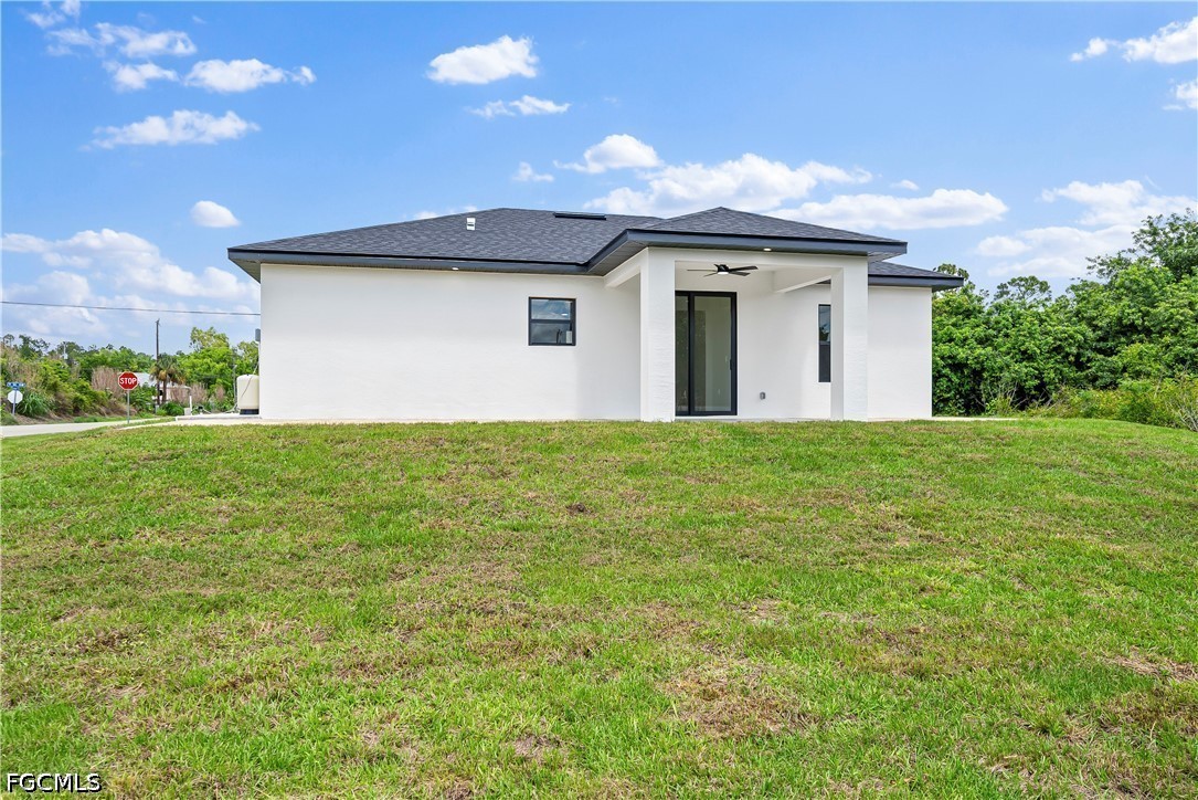 2919 9th Street Southwest Lehigh Acres, FL 33976 - Photo 20 of 29 a front view of a house with yard and garage