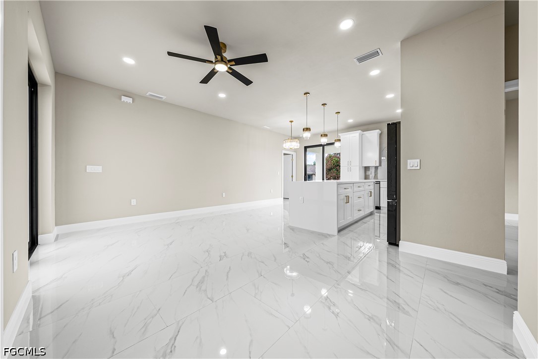 2919 9th Street Southwest Lehigh Acres, FL 33976 - Photo 5 of 29 an empty room with kitchen and windows