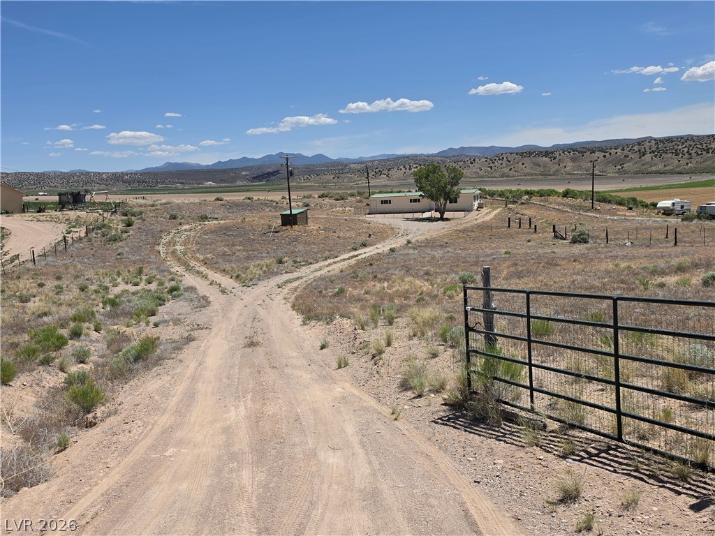 2930 Frehner Ranch Road Pioche, NV 89043 - Photo 2 of 39 Discover vast, open plains stretching towards distant mountains, offering serene rural living.