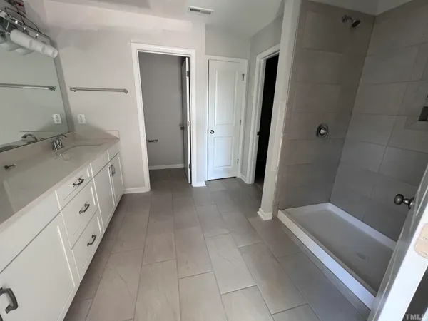 a bathroom with a double vanity sink and mirror