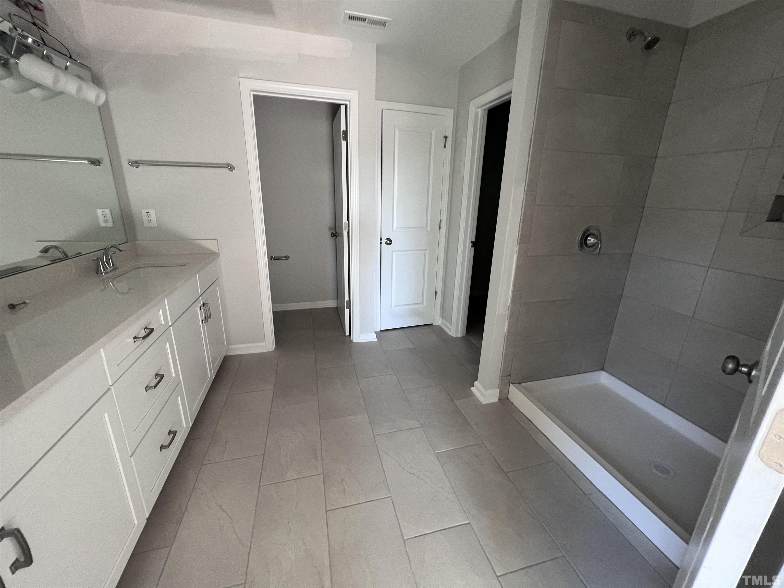 2312 Grants Pass Station Apex, NC 27502 - Photo 14 of 18 a bathroom with a double vanity sink and mirror