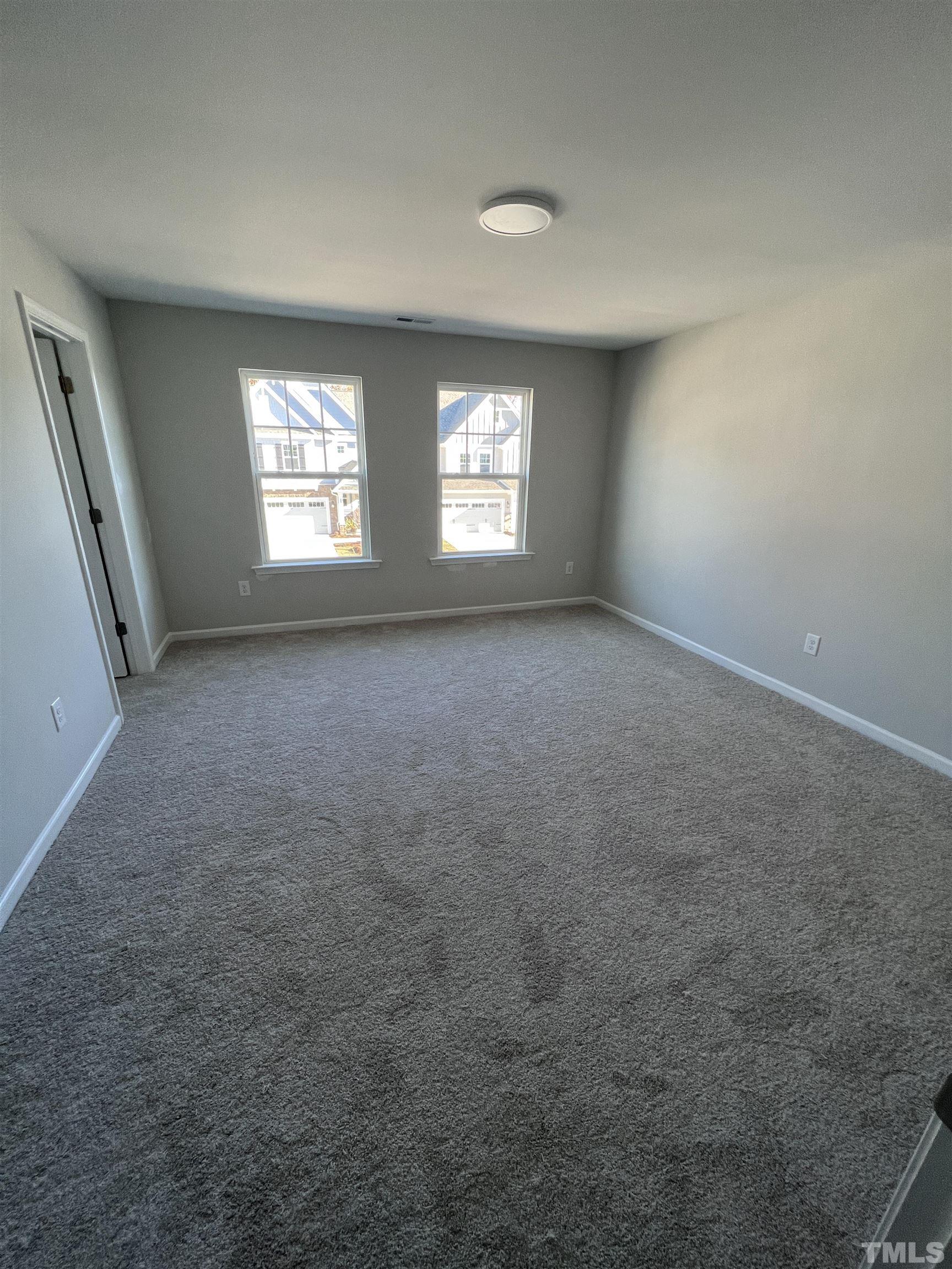 2312 Grants Pass Station Apex, NC 27502 - Photo 17 of 18 an empty room with windows and closet