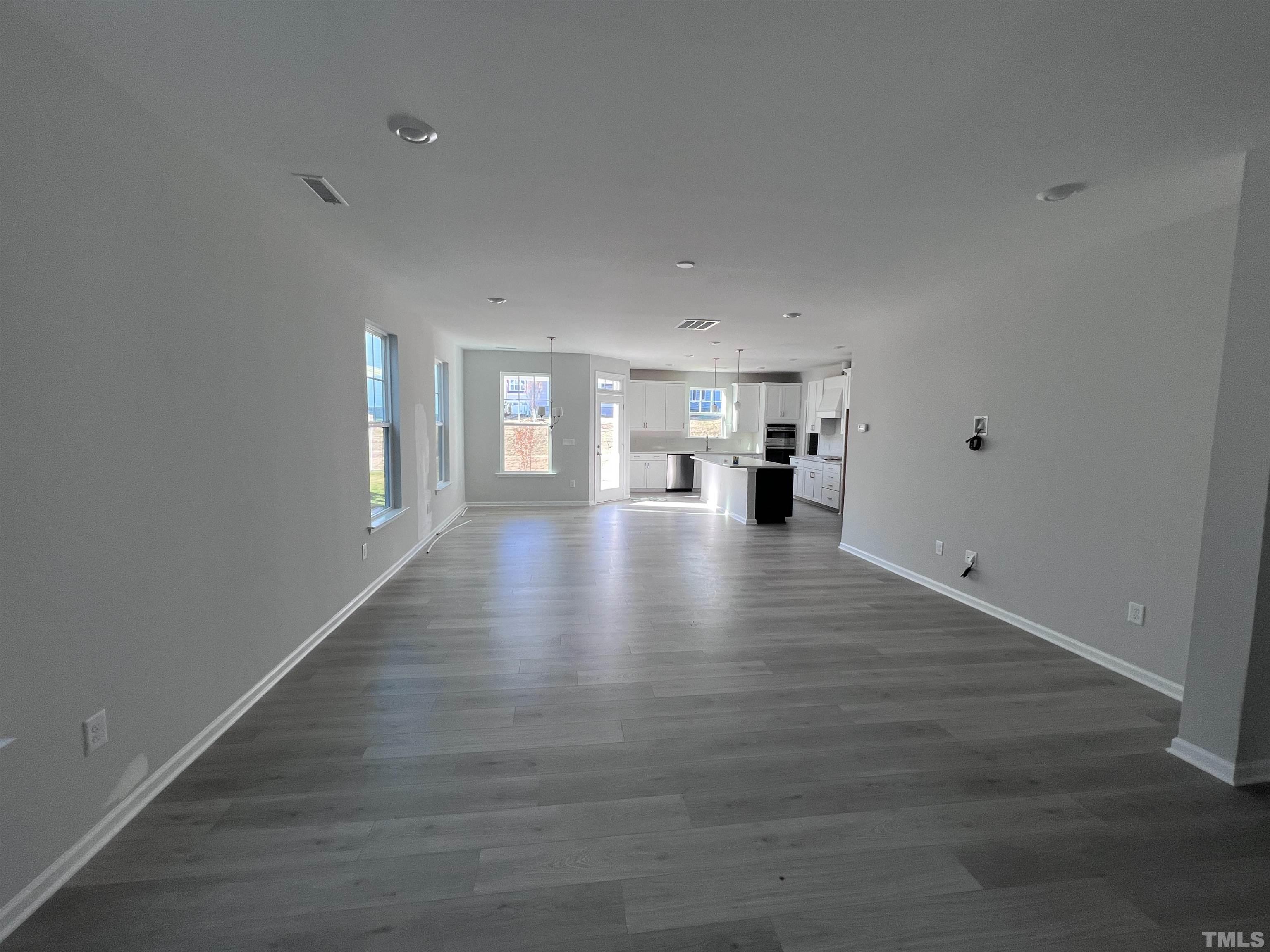 2312 Grants Pass Station Apex, NC 27502 - Photo 5 of 18 a view of empty room with wooden floor