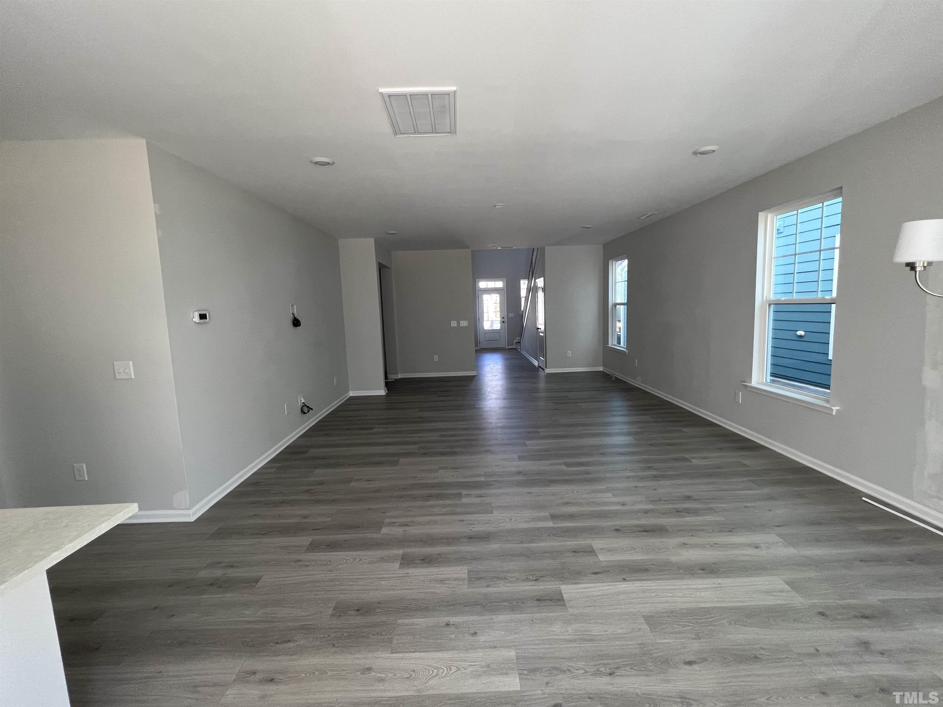 2312 Grants Pass Station Apex, NC 27502 - Photo 6 of 18 a view of an empty room with wooden floor