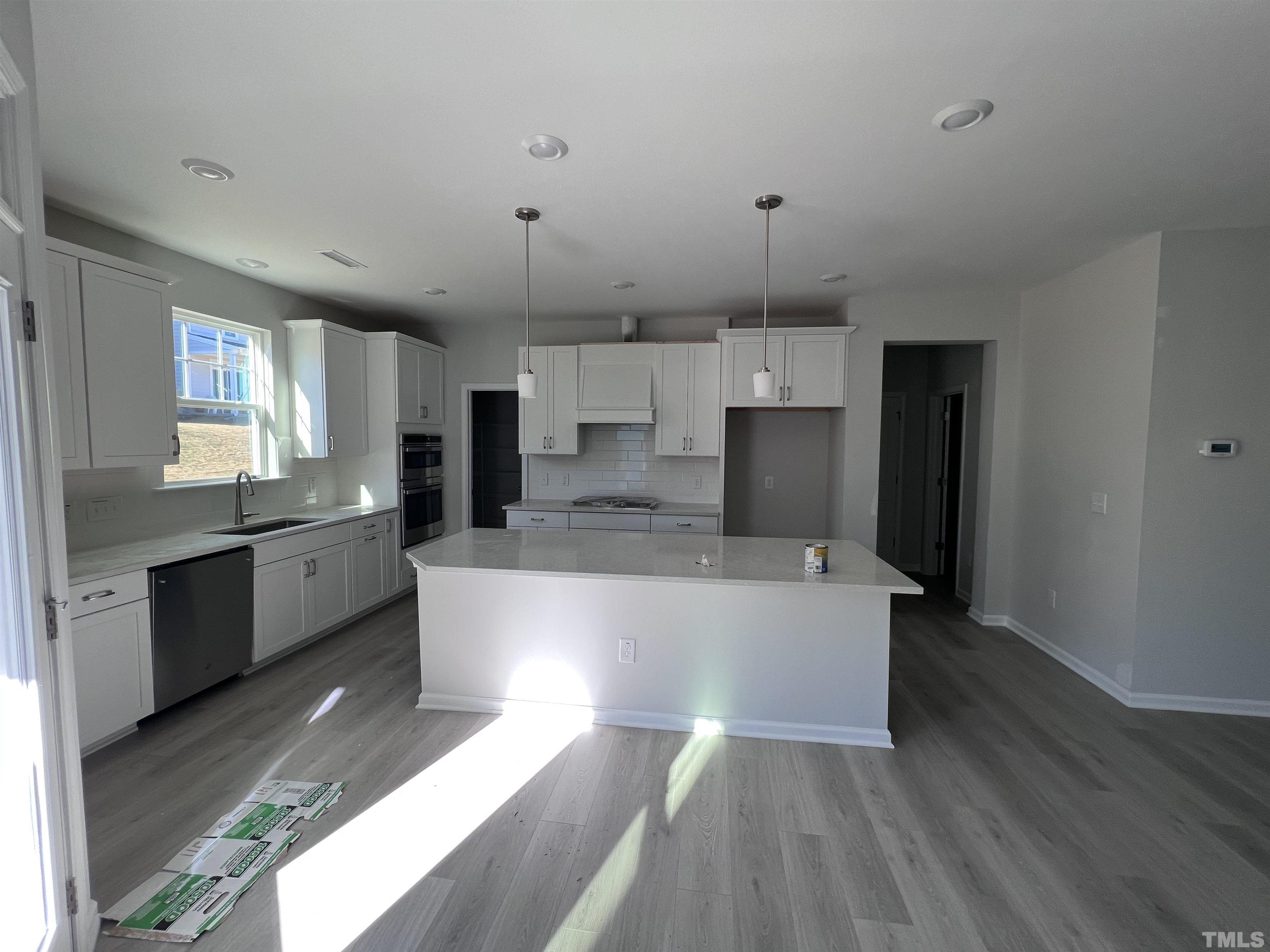 2312 Grants Pass Station Apex, NC 27502 - Photo 7 of 18 a large kitchen with a large counter top stainless steel appliances and cabinets