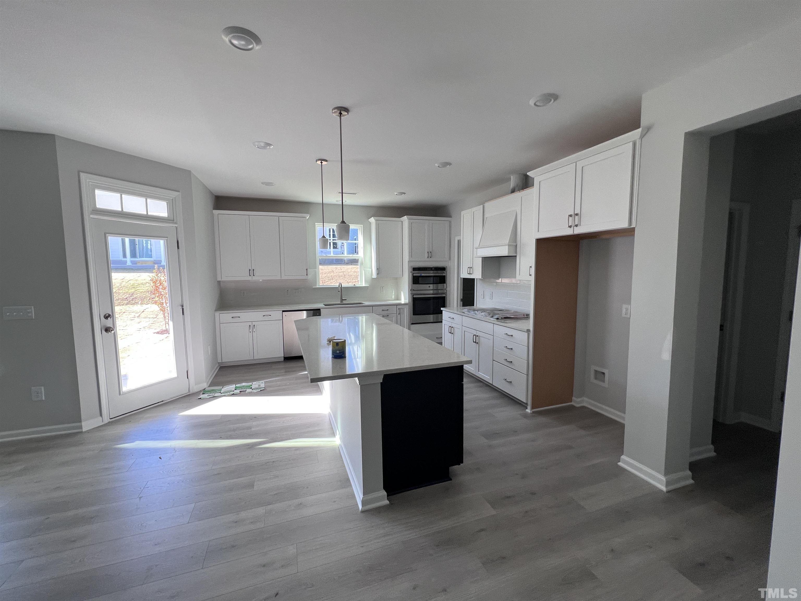 2312 Grants Pass Station Apex, NC 27502 - Photo 8 of 18 a large kitchen with stainless steel appliances kitchen island granite countertop a refrigerator and a sink