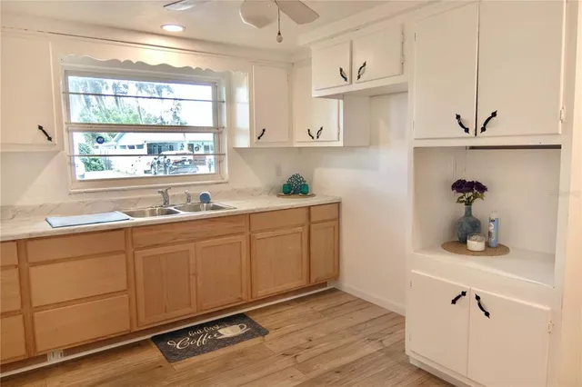 a kitchen with sink cabinets and window