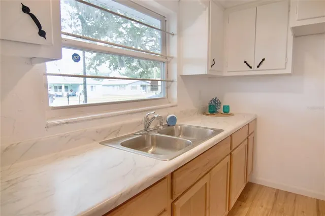 a view white cabinets and a sink
