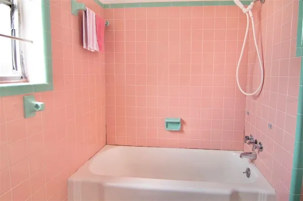 a bathroom with a white bathtub