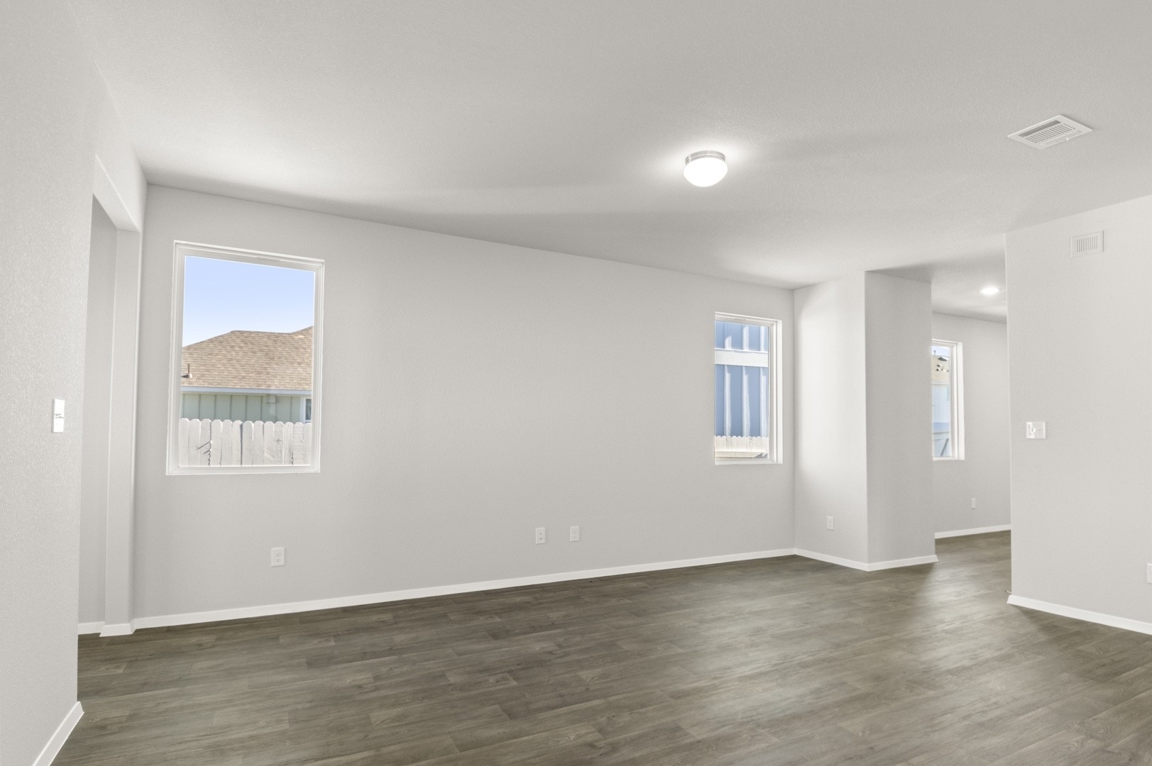 149 Daylily Drive Elgin, TX 78621 - Photo 11 of 31 an empty room with wooden floor and windows
