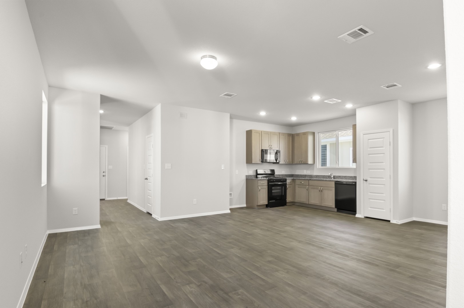 149 Daylily Drive Elgin, TX 78621 - Photo 12 of 31 a view of a kitchen with refrigerator and a sink