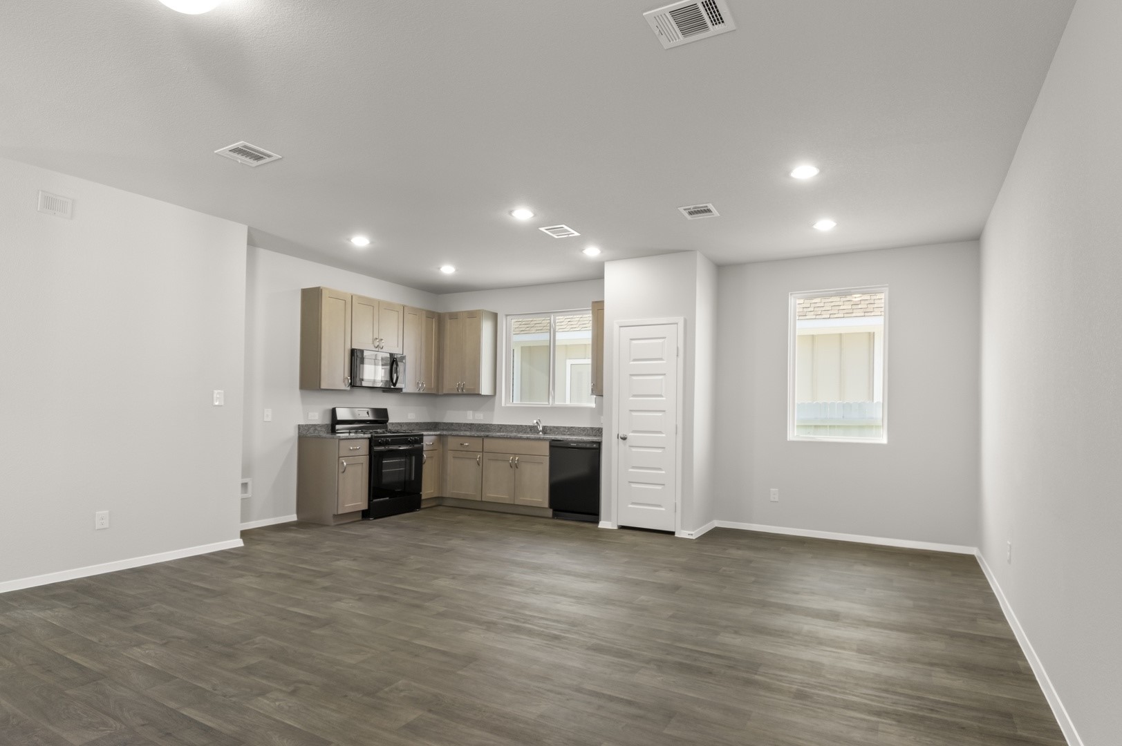 149 Daylily Drive Elgin, TX 78621 - Photo 13 of 31 a large white kitchen with a sink a microwave and cabinets