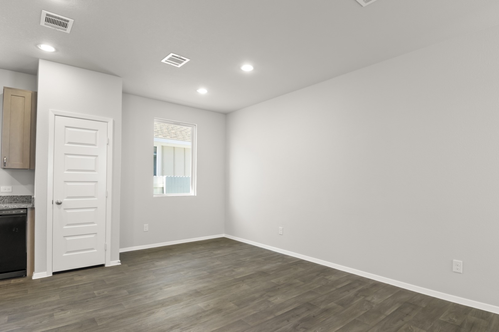 149 Daylily Drive Elgin, TX 78621 - Photo 14 of 31 wooden floor in an empty room with a window
