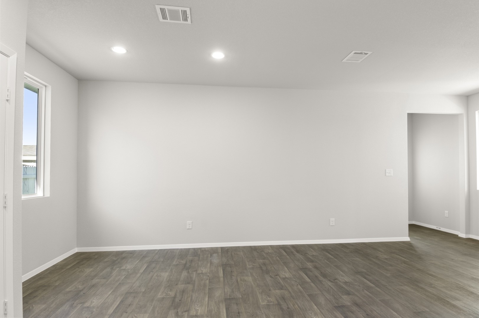 149 Daylily Drive Elgin, TX 78621 - Photo 15 of 31 a view of an empty room with wooden floor and a window