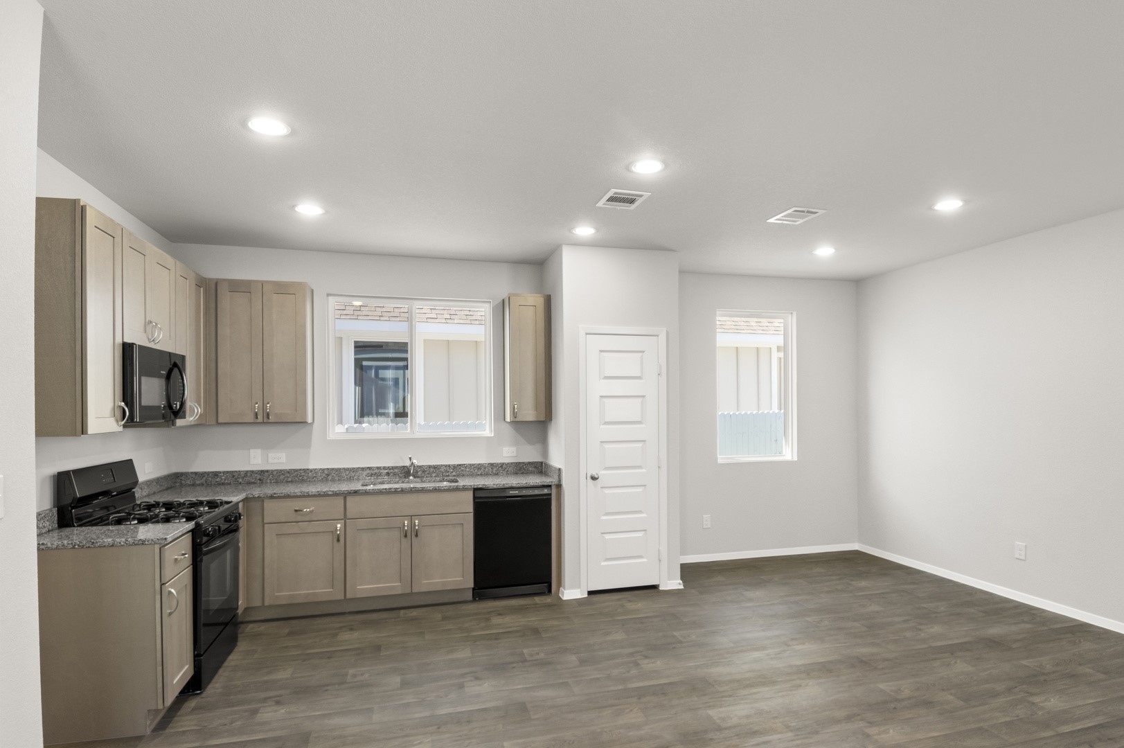 149 Daylily Drive Elgin, TX 78621 - Photo 17 of 31 a large kitchen with stainless steel appliances granite countertop a stove and a sink