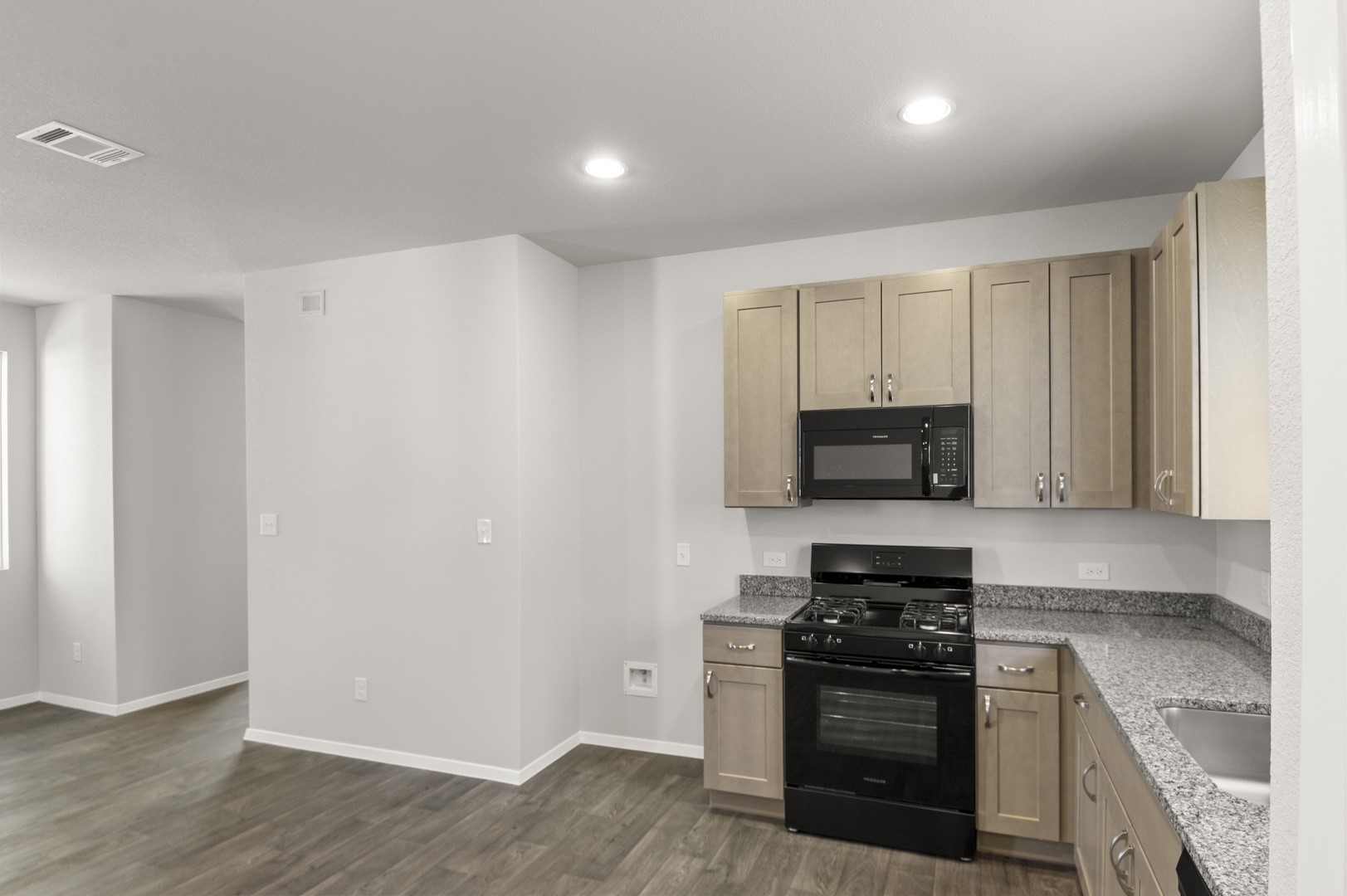 149 Daylily Drive Elgin, TX 78621 - Photo 18 of 31 a kitchen with granite countertop a stove and a sink