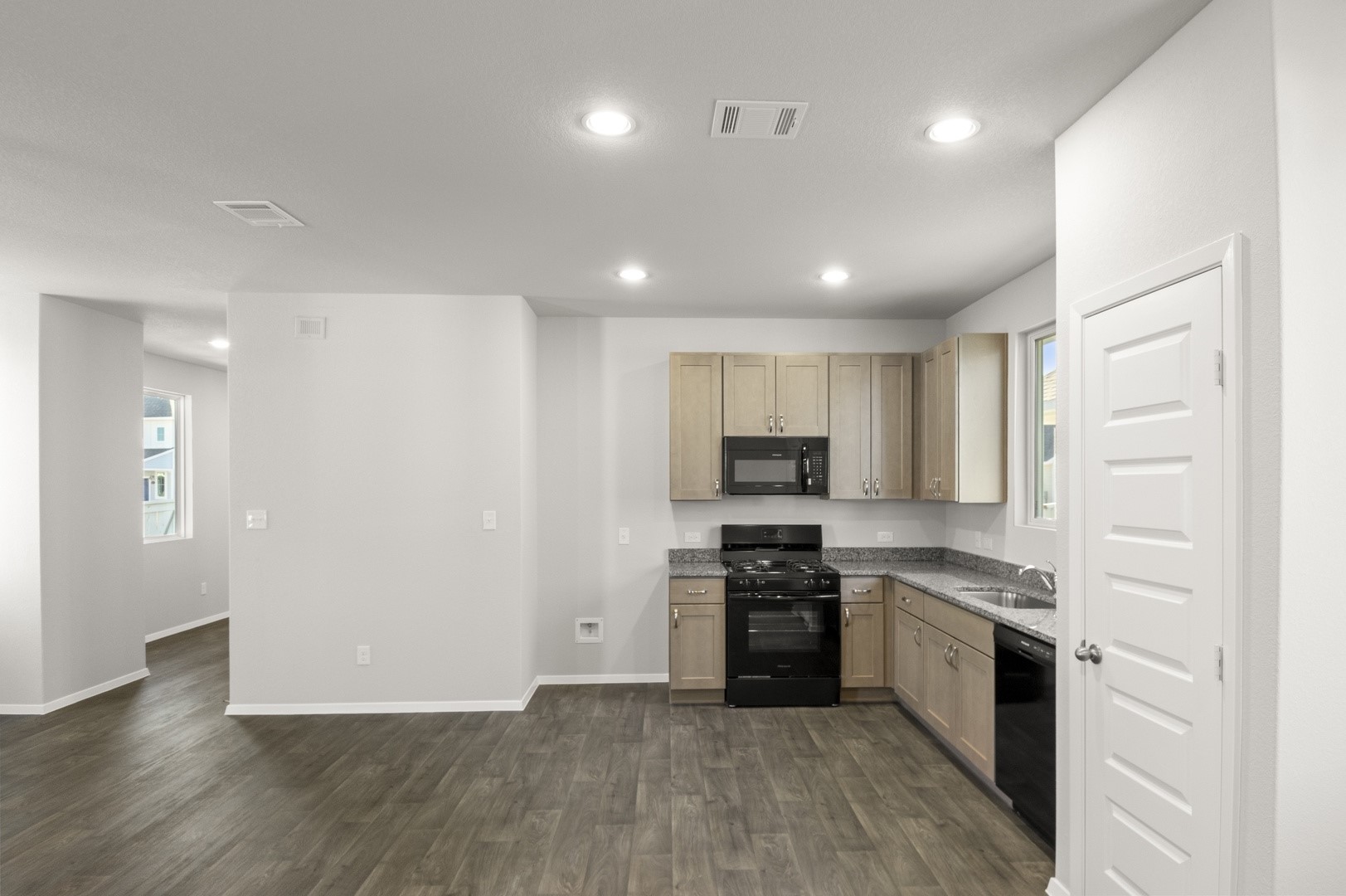149 Daylily Drive Elgin, TX 78621 - Photo 19 of 31 a kitchen with stainless steel appliances granite countertop a stove top oven a sink and a refrigerator