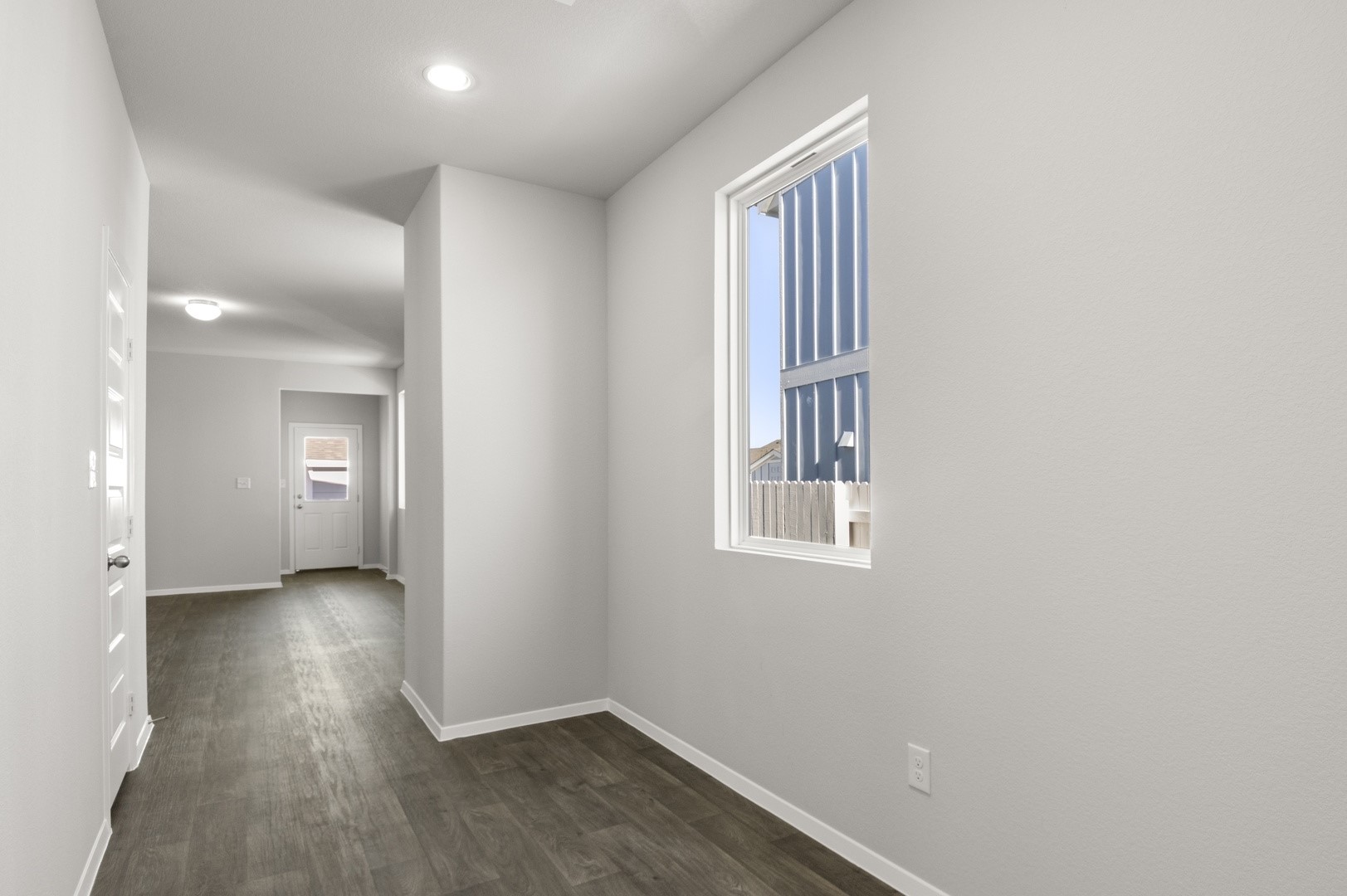 149 Daylily Drive Elgin, TX 78621 - Photo 7 of 31 an empty room with wooden floor and a window
