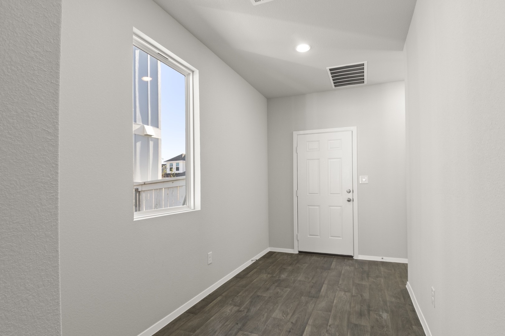 149 Daylily Drive Elgin, TX 78621 - Photo 8 of 31 a view of an empty room with wooden floor and a window