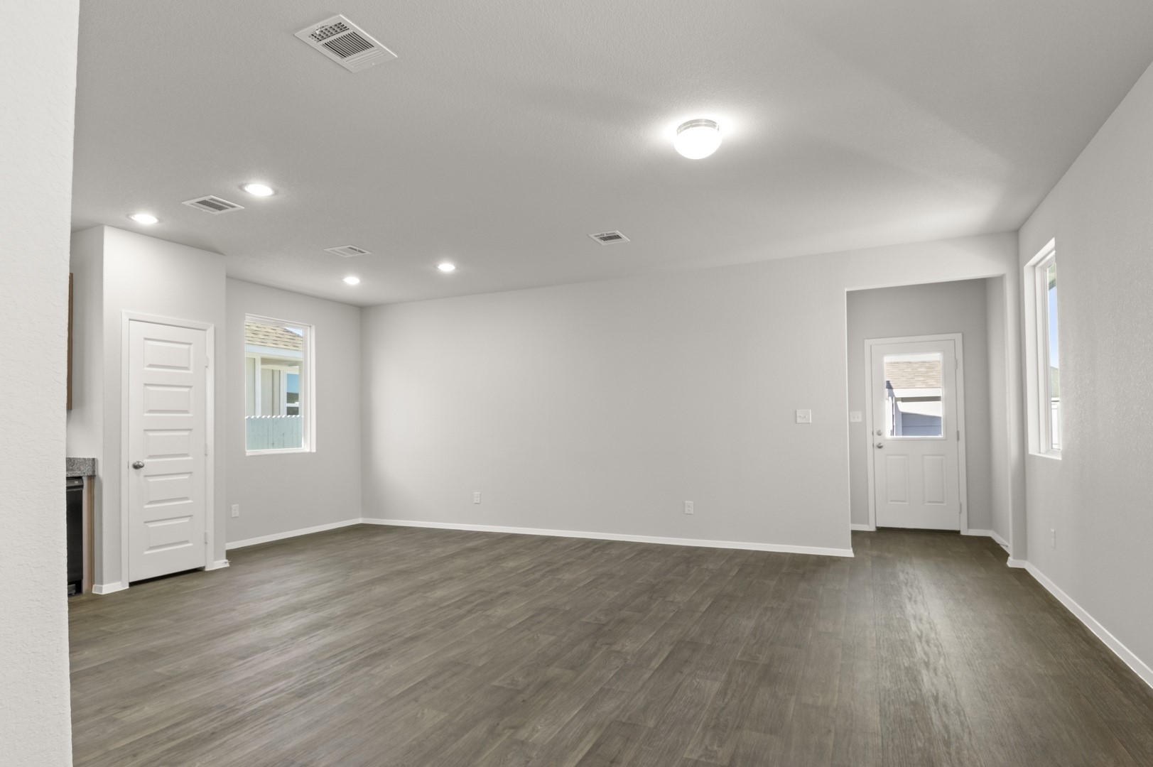 149 Daylily Drive Elgin, TX 78621 - Photo 9 of 31 wooden floor in an empty room with a window