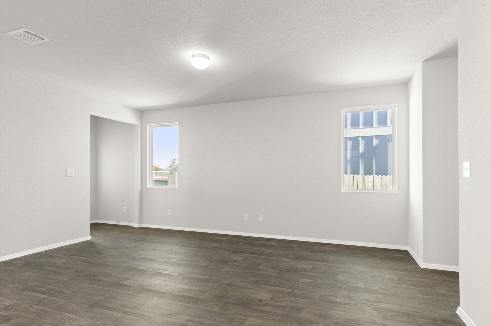 149 Daylily Drive Elgin, TX 78621 - Photo 10 of 31 a view of an empty room with wooden floor and a window