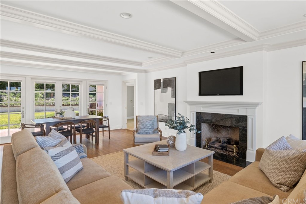 1300 Granvia Altamira Palos Verdes Estates, CA 90274 - Photo 14 of 60 a living room with furniture a fireplace and a flat screen tv