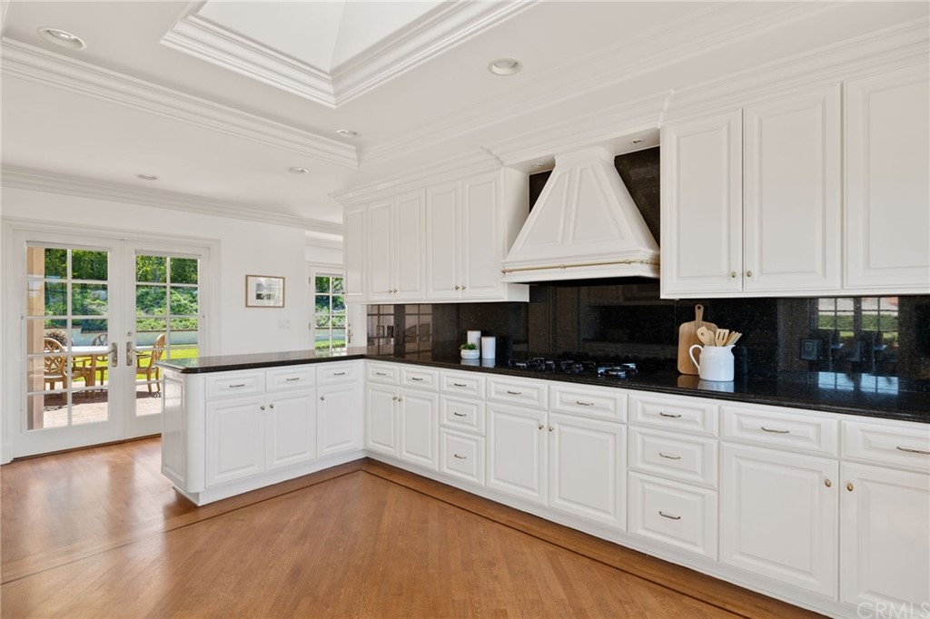 1300 Granvia Altamira Palos Verdes Estates, CA 90274 - Photo 21 of 60 a large kitchen with granite countertop a white cabinets and a wooden floor