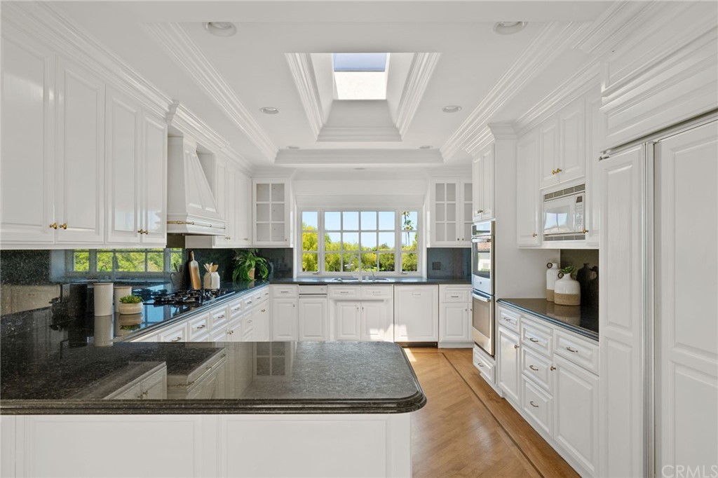 1300 Granvia Altamira Palos Verdes Estates, CA 90274 - Photo 24 of 60 a kitchen with stainless steel appliances granite countertop a stove a sink and a refrigerator