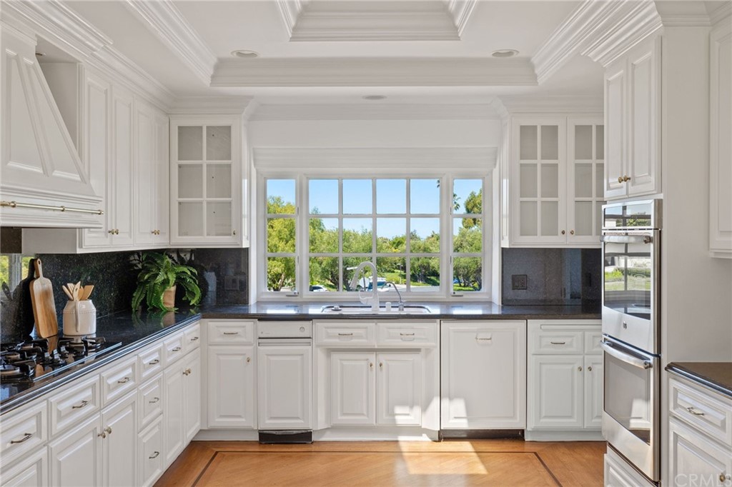 1300 Granvia Altamira Palos Verdes Estates, CA 90274 - Photo 25 of 60 a kitchen with stainless steel appliances a white cabinets and a window