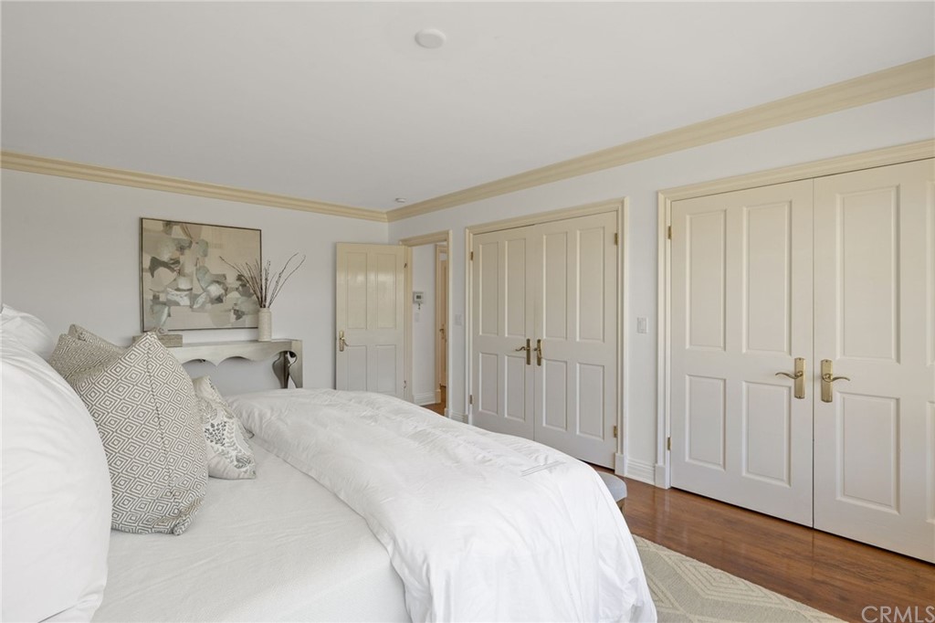 1300 Granvia Altamira Palos Verdes Estates, CA 90274 - Photo 31 of 60 a spacious bedroom with a bed and a painting on the wall