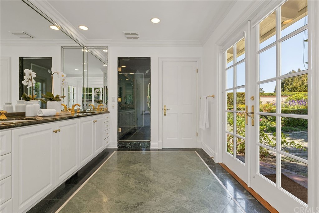 1300 Granvia Altamira Palos Verdes Estates, CA 90274 - Photo 32 of 60 a bathroom with a granite countertop sink and a large mirror