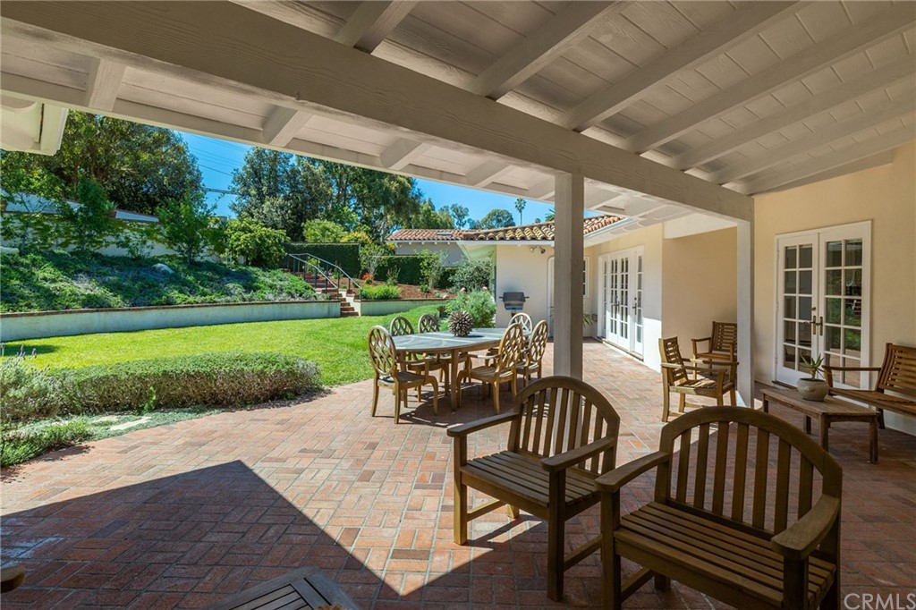 1300 Granvia Altamira Palos Verdes Estates, CA 90274 - Photo 47 of 60 a view of a patio with chairs and floor to ceiling window