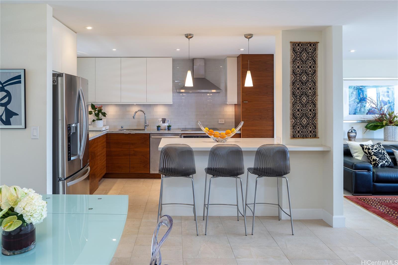 a kitchen with stainless steel appliances granite countertop a refrigerator and a sink