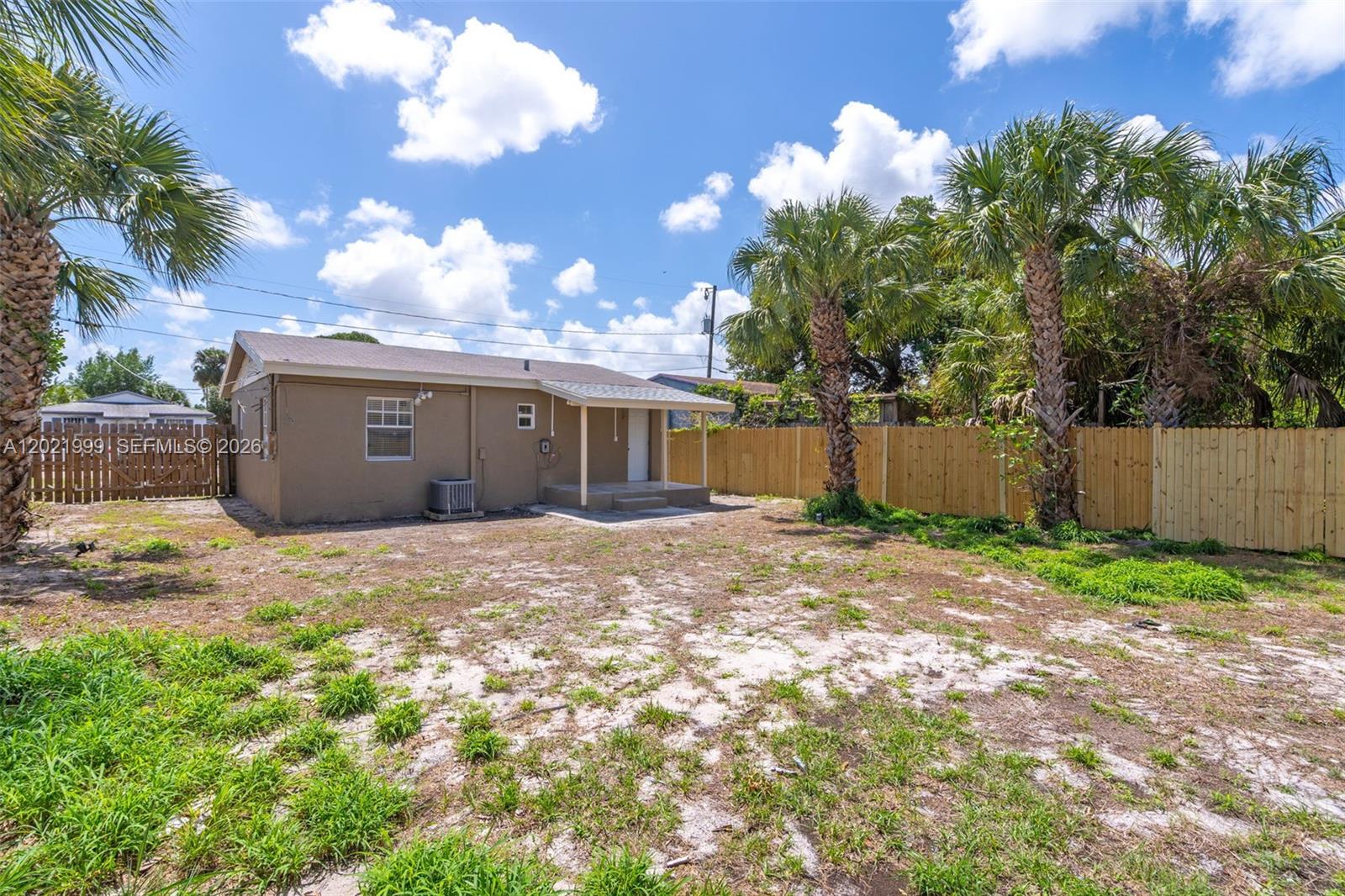 1660 West 26th Street Riviera Beach, FL 33404 - Photo 23 of 28 a view of a house with a yard and garage