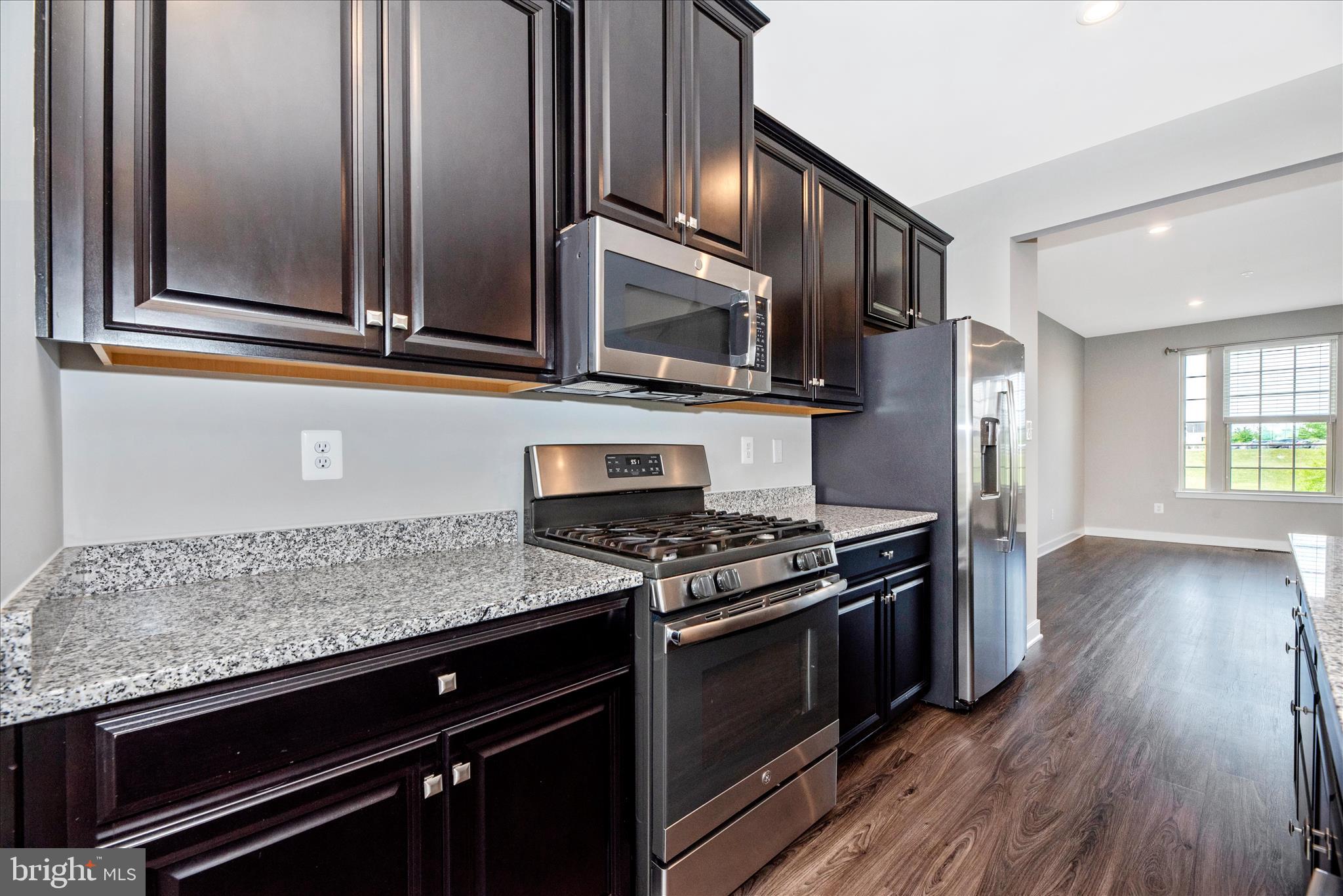 7091 Kokanee Way New Market, MD 21774 - Photo 20 of 69 a kitchen with stainless steel appliances granite countertop a stove and a microwave