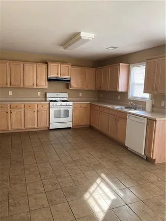 a kitchen with stainless steel appliances granite countertop a sink and cabinets