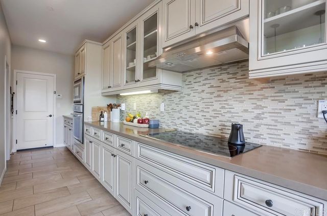 a kitchen with stainless steel appliances a sink and cabinets