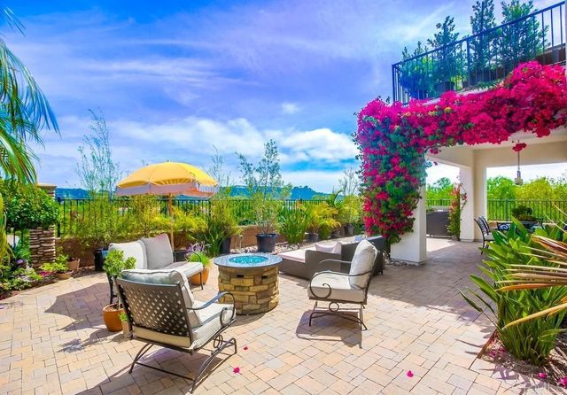 a patio with tables and chairs