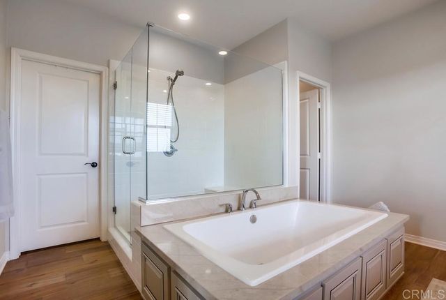 a bathroom with a sink a mirror and a shower