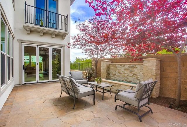 a view of a patio with table and chairs and potted plants