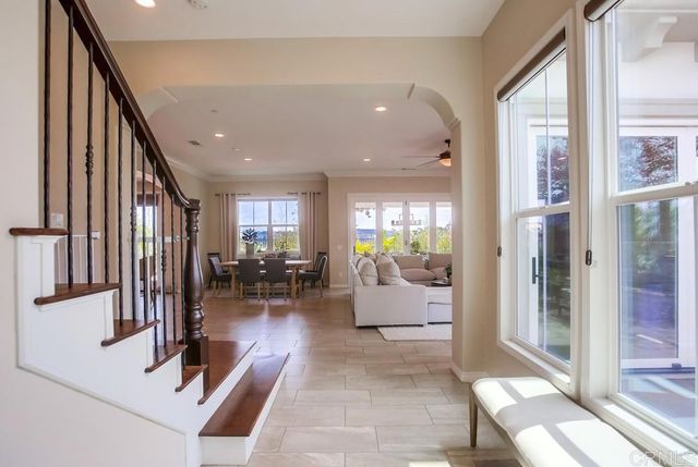 a view of a hall with living room and windows