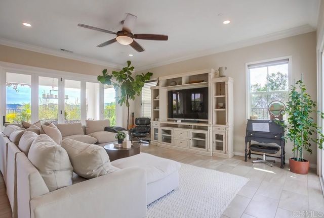 a living room with furniture tv and a large window